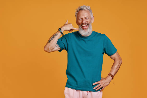 istock Happy senior man doing call me gesture and smiling 1327105754