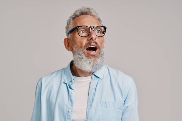 istock Shocked senior man keeping mouth open and looking away 1327106558