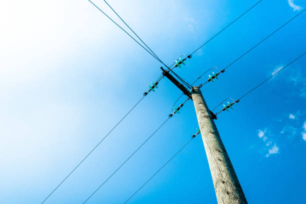 Clouds against blue sky with telegraph pole Clouds against blue sky with telegraph pole utility pole with power lines close up stock pictures, royalty-free photos & images