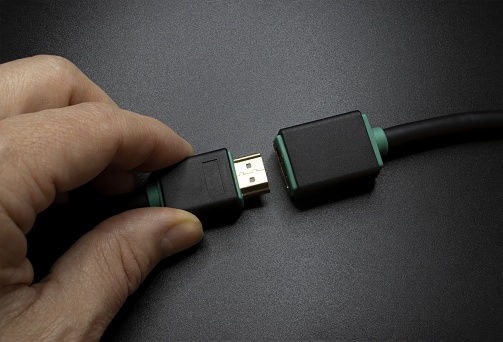 Connecting an HDMI Cable isolated on gray background