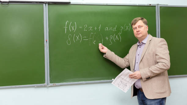 istock A male school math teacher at the blackboard explains the solution of the problem 1327108221