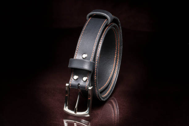 istock Leather belt with a metal buckle close-up on a dark background. 1327108614