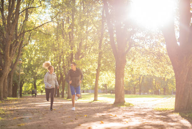 istock Happy couple running and talking in public park 1327110738