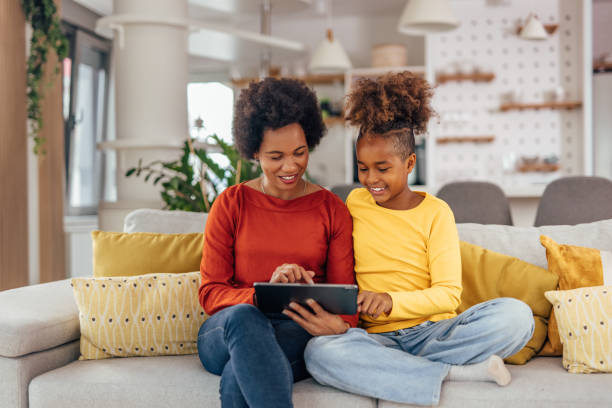 istock Mother and daughter downloading music. 1327111069