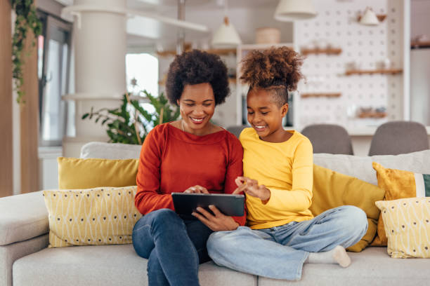 istock Black girl, helping her mom with her work. 1327111071