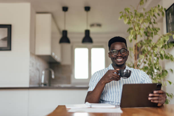 istock Adult African man, browsing the internet. 1327112157