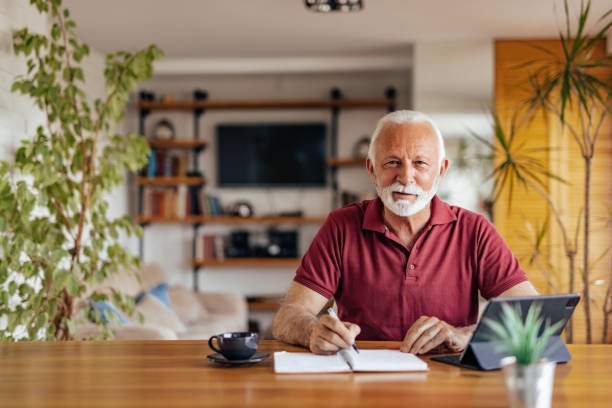 istock Senior man, making sure his day is noted. 1327112484