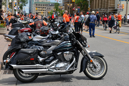 Ottawa, Canada - July 1, 2021: A row of motorcycles in front of Parliament Hill during the Cancel Canada Day rally. They believe it is not proper to celebrate Canada Day in light of the recent discovery of unmarked graves on residential school grounds.