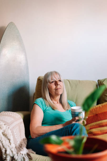 istock Senior woman having coffee at home 1327114466
