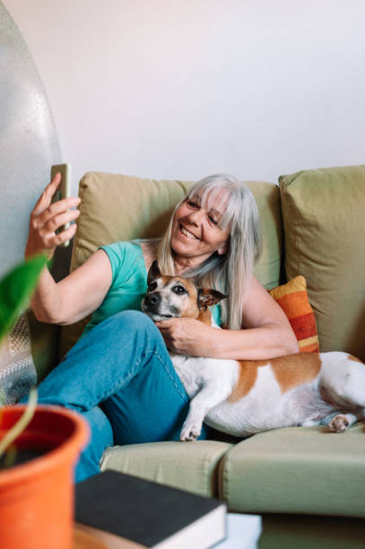 istock Senior woman taking selfie with dog 1327114467