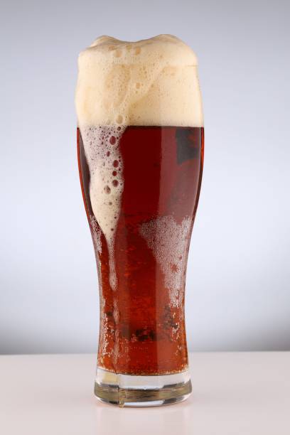 istock Glass with light brown beer on a white background 1327114661