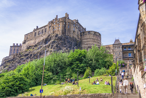 Edinburgh, Scotland - People enjoying warm sunny weather in Edinburgh, with a view of the Castle from the Grassmarket.