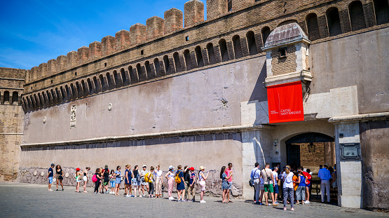 Rome, Italy, July 03 -- Dozens of tourists wait in line to visit Castel Sant'Angelo, in the historic heart of Rome and close to the Vatican. Castel Sant'Angelo, built around 123 AD as a sepulcher for Emperor Hadrian and his family, was used as a fortress, prison and refuge by the Popes due his proximity with the Vatican. It is currently owned by the Italian State and is used for visits and cultural events. Image in High Definition format.