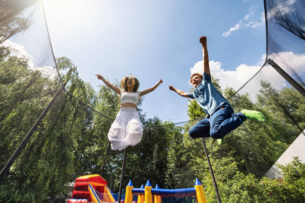 istock Kids jumping on trampoline 1327117040