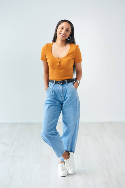 Full length portrait of an attractive young woman standing with her hands in her pockets in studio She's got stye hands in pockets stock pictures, royalty-free photos & images