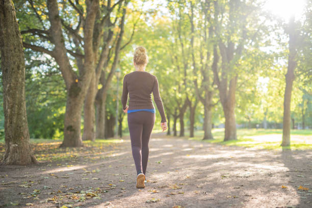 istock Young woman walking at public park 1327118678