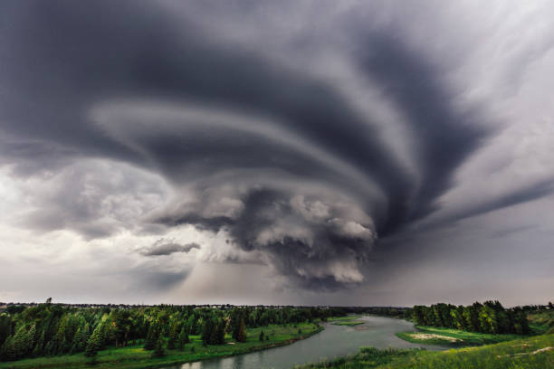 Incoming Storm over the Bow River in Calgary An ominous storm rolls in over the Bow River in Calgary extreme weather stock pictures, royalty-free photos & images