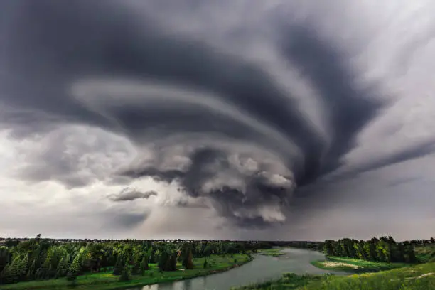 An ominous storm rolls in over the Bow River in Calgary