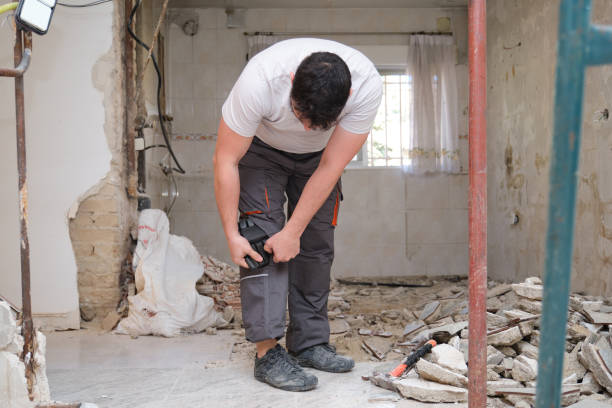 istock Young builder wearing knee protection pads to work in a construction. Safety at work. 1327121222