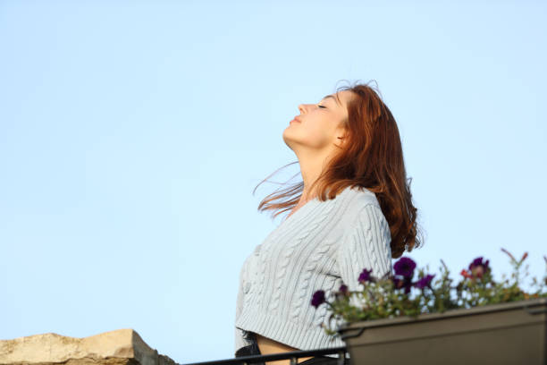 istock Relaxed home owner breathing fresh air from a balcony 1327122435