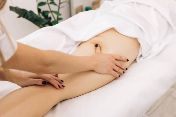 istock Professional is massaging and touching skin of female client, using traditional techniques. Specialist works with body of patient. Masseur is doing massage of back of woman lying in beauty salon 1327122592