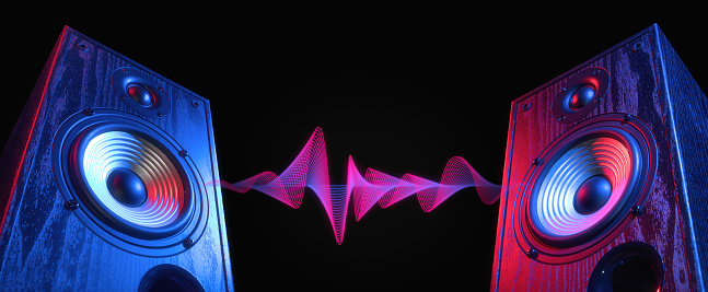 Dos altavoces de sonido en luz de neón con onda de sonido. photo