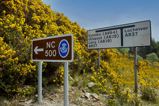 Scottish Highlands, UK - May 2021: North Coast 500 (NC500) road signs in the Scottish Highlands, UK
