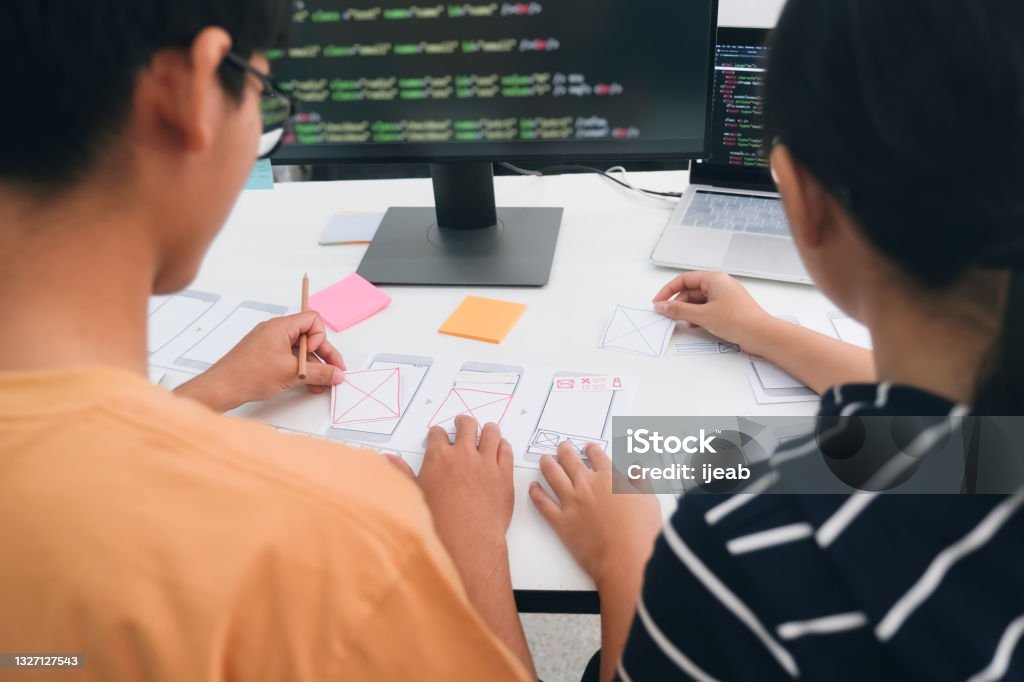 UX UI and Programming development technology. Programmer and UX UI designer working in a software development and coding technologies. Mobile and website design and programing development technology. Computer Programmer Stock Photo