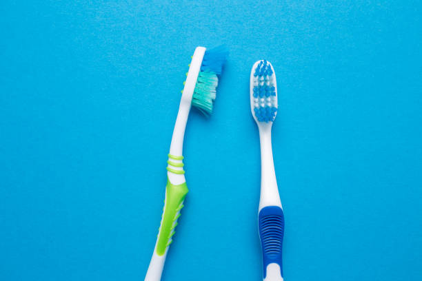 istock Used old and new toothbrush on a blue background 1327132268