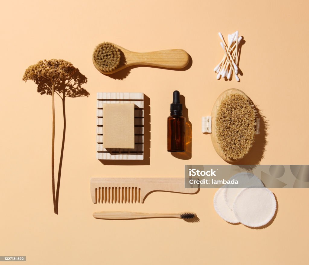 Zero waste self-care kit Eco friendly toiletries and beauty products: face and body brushes, cotton pads and swabs, serum, soap, toothbrush and hair comb Flat Lay Stock Photo