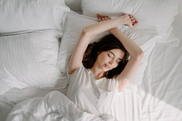 istock Young woman sleeping in cozy bedroom alone 1327134777