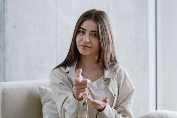 istock Young woman looking at camera, gesturing with hands 1327134791