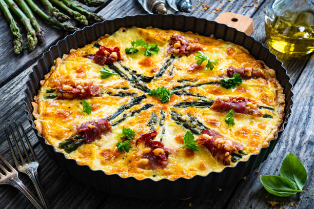 istock Tart with asparagus and serrano ham on wooden table 1327138275