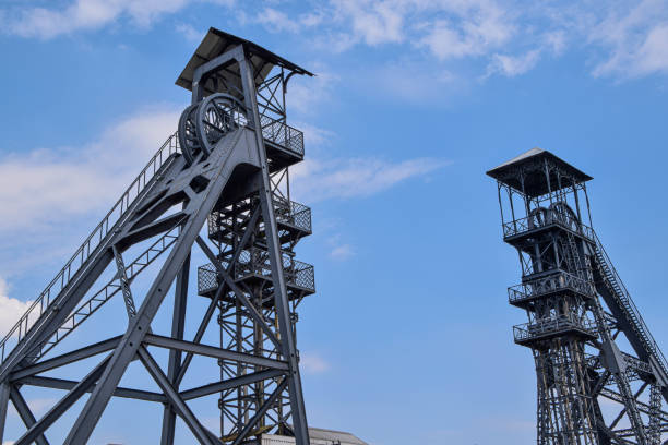old mine lifts of the bois du cazier coal mine in charleroi belgium - old crane blue sky imagens e fotografias de stock