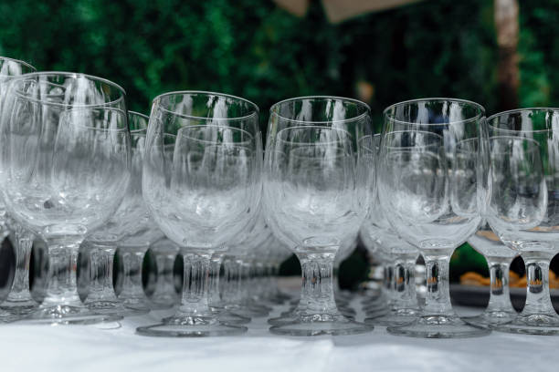 istock Many empty wine glasses in a line, close-up. Rows of empty wine glasses on the wedding table. Buffet in the open air. Catering background concept. Selective focus 1327143468