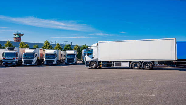 Trucks of transportation companies waiting at a truck stop. stock photo