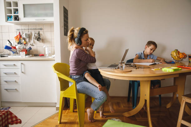 woman getting annoyed by her son who is interrupting her work video conference - inconvenience meeting business distracted imagens e fotografias de stock