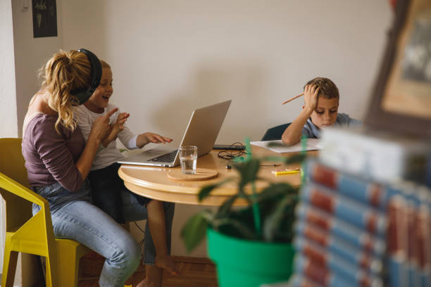 mother scolding her mischievous son interrupting her work - inconvenience meeting business distracted imagens e fotografias de stock