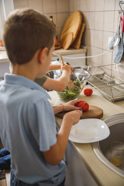 istock Cutting up tomatoes and mixing up the salad 1327148639