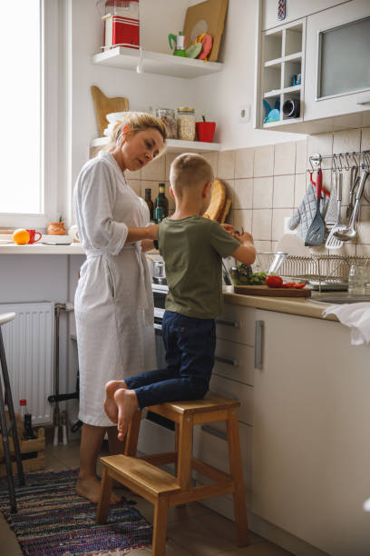 istock Mother and son bonding while preparing food together 1327148725