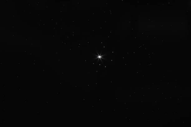 istock black christmas background with bright stars 1327150447
