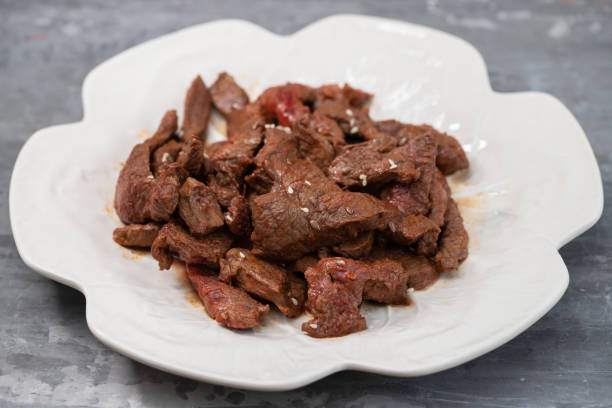 istock fried meat with sauce on white dish 1327150683
