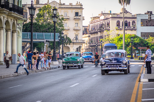 August 1, 2018 - La Havana, Cuba: Cityscape with american red vintage car on the main street in Havana City Cuba