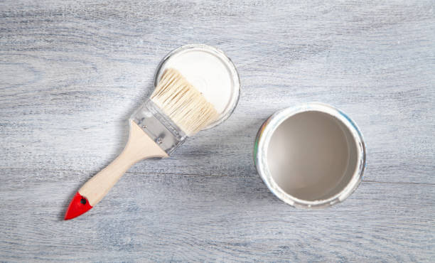istock White paint and brush on the white background. 1327152124