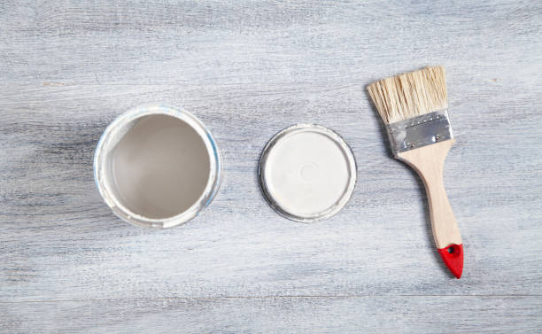 istock White paint and brush on the white background. 1327152133