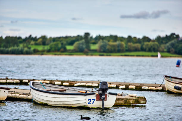 istock Small motorboat moored in a lake 1327154611