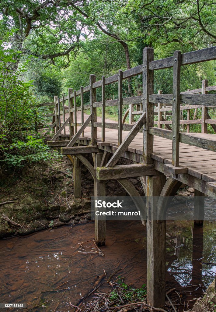 Pooh Bridge located in the One Hundred Acre woods in the stories by AA Milne of Christopher Robin and Winnie the Pooh . Pooh Sticks bridge were Pooh sticks originated located in the One Hundred Acre wood in Ashdown Forest near Hartfield. Ashdown Forest Stock Photo