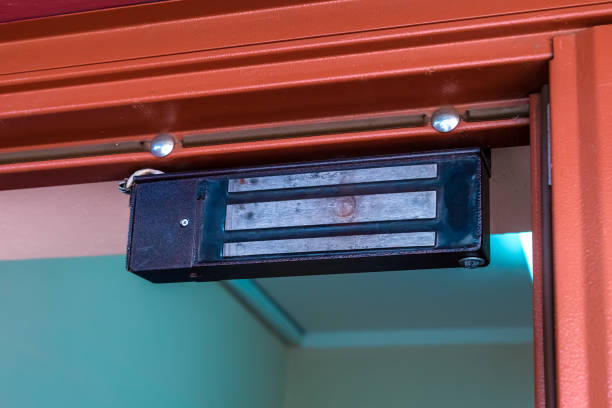 An electric magnet on the front door from above.