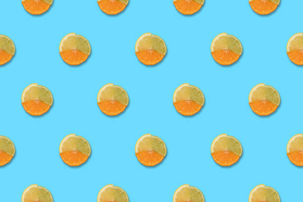 istock Lemon, orange and lime slices pattern on blue background. Minimal trendy Summer or Spring concept 1327158383