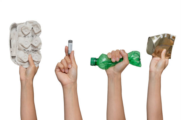 istock Recycling Garbage and separate Trash. Hand holding waste cardboard, battery, pet, can on isolated white background. 1327158988